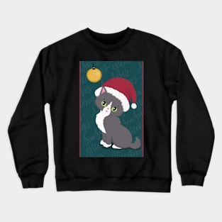 Cute Christmas card with a little kitten in a Christmas hat looking at a bauble. Crewneck Sweatshirt